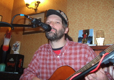 Photo of Alan Robinson playing guitar at the Travellers Rest pub in Draycott Derbyshire
